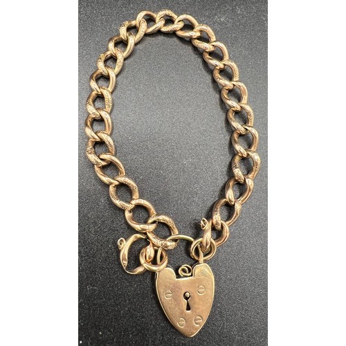 612 - A 9ct gold bracelet with heart shaped padlock and two spare links. 10.9gm.