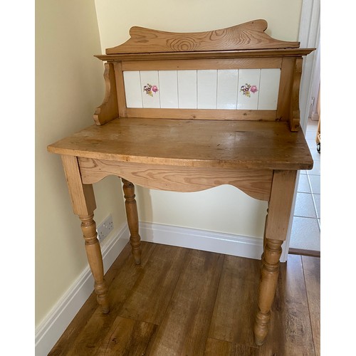 141 - A pine washstand with tiles to back. 106 h x 76 w x 46cm d.