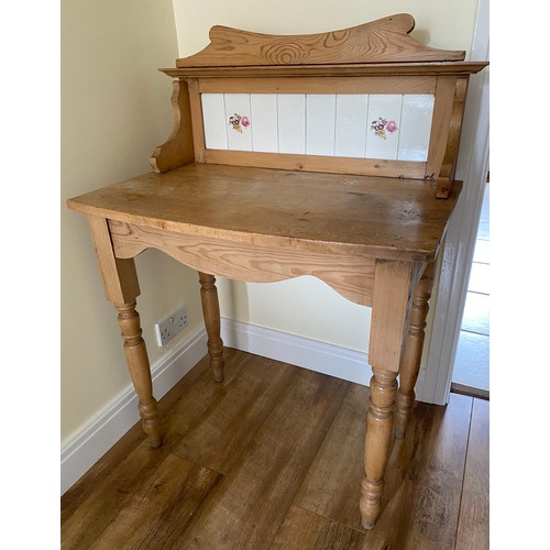 141 - A pine washstand with tiles to back. 106 h x 76 w x 46cm d.