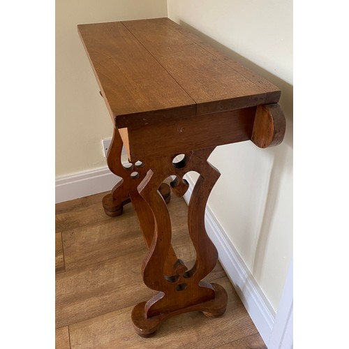 142 - Side table with decorative sides on bun feet, 72 h x 67 w x 28cm d.