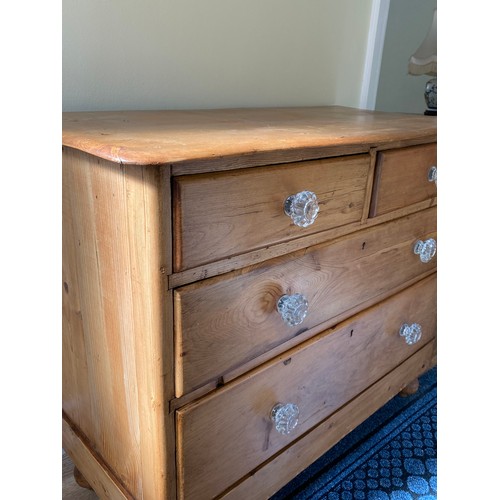 143 - A 19thC pine chest of 2 short over 2 long drawers, serpentine front with glass knobs. 82 h x 102 w x... 