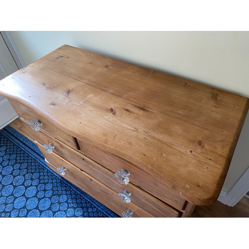 143 - A 19thC pine chest of 2 short over 2 long drawers, serpentine front with glass knobs. 82 h x 102 w x... 