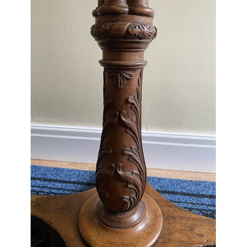 146 - A mahogany occasional table with well carved pedestal.