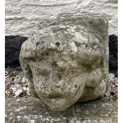 202 - An early stone carving of a head, probably medieval. 23 h x 21 w x 35cm d.