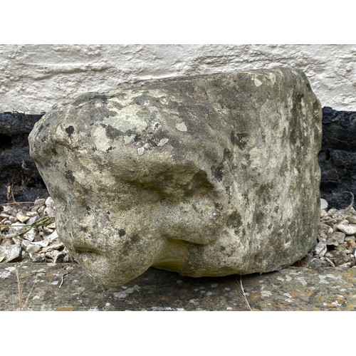 202 - An early stone carving of a head, probably medieval. 23 h x 21 w x 35cm d.