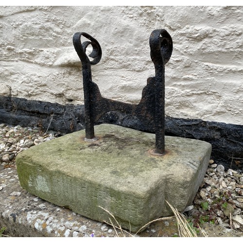 203 - A boot scraper set in stone. 36 w x 29 d x 35cm h to top of scraper.