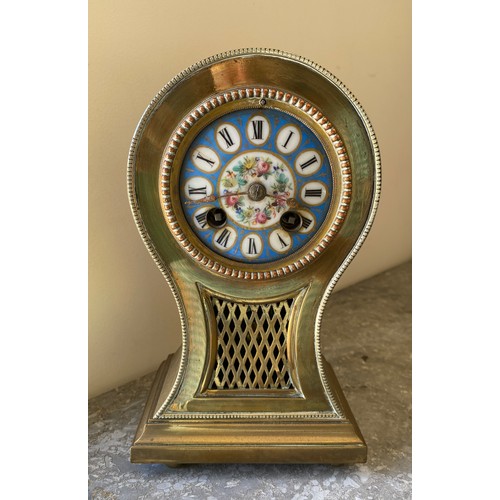 1039 - Brass mantle clock with enamelled face, roman numerals and chiming bell.