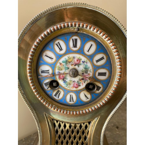 1039 - Brass mantle clock with enamelled face, roman numerals and chiming bell.