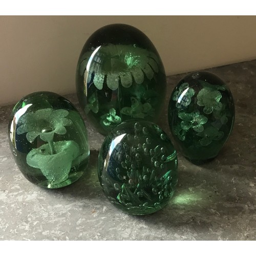 502 - Four green paperweights. 14cm h.