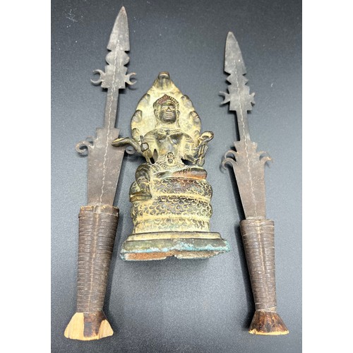 768 - Antique bronze figure of Shiva 15cm h with a pair of metal spear heads mounted on wooden stands.