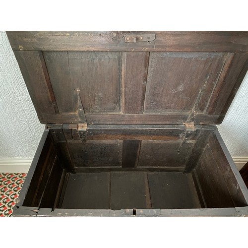 78 - An 18thC oak coffer with carving to frieze and panels. Metal handles to sides. 97 w x 48 d x 59cm h.