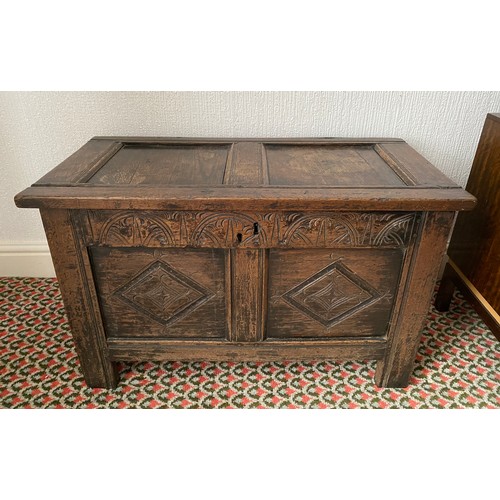 78 - An 18thC oak coffer with carving to frieze and panels. Metal handles to sides. 97 w x 48 d x 59cm h.