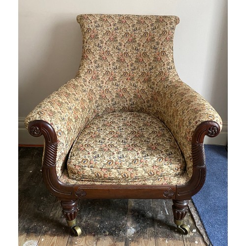 82 - A Regency mahogany framed armchair in the manor of Gillows of Lancaster and London on brass castors....