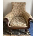 A Regency mahogany framed armchair in the manor of Gillows of Lancaster and London on brass castors.... 