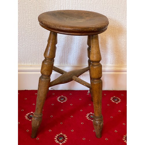 85 - A 19thC four legged stool with circular top. 50cm h.