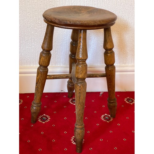 85 - A 19thC four legged stool with circular top. 50cm h.