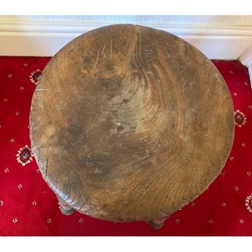 85 - A 19thC four legged stool with circular top. 50cm h.