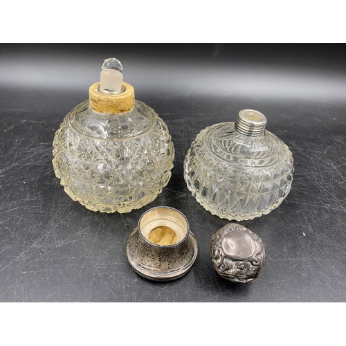 788 - Two cut glass perfume bottles with silver collars and lids. Tallest 10.5cm.