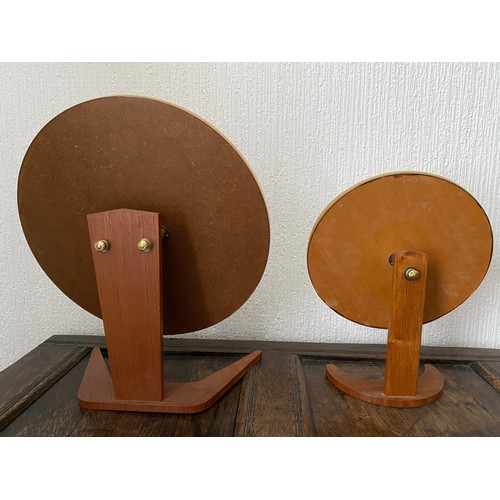 1149 - Two mid 20thC circular mirrors on teak bases. Largest height 49 x 41d , smaller 39 h x 29cm d.