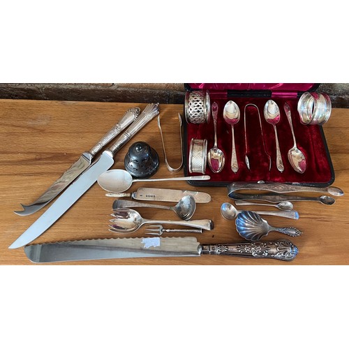 802 - A quantity of hallmarked silver to include 3 napkin rings, silver handled knives, sugar tongs, sugar... 