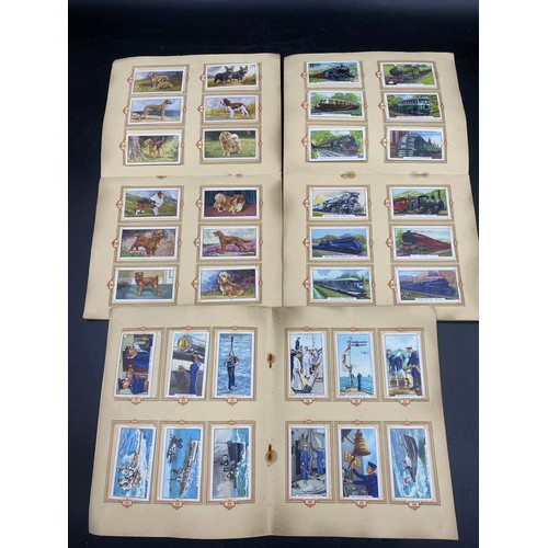 1063 - Five complete albums of cigarette cards to include three Park Drive:- The Navy 1937, Dogs 1937, Trai... 