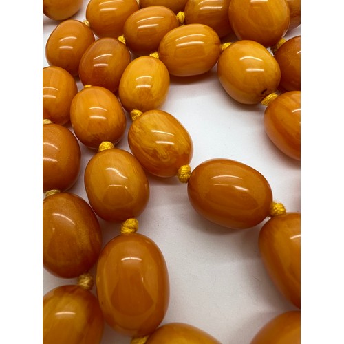 566 - Two string of butterscotch amber beads, approx length 80 & 52cm. 213.9gm.