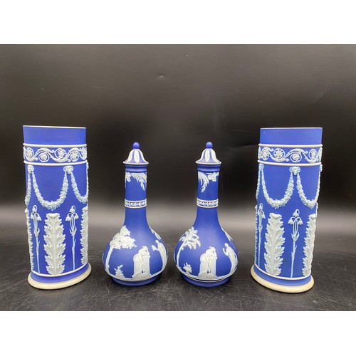 289 - Two pairs of Wedgwood blue and white jasperware vases. Two with lids 7cm h, two cylindrical shaped 9... 