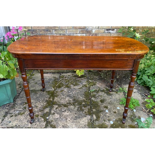 74 - Mahogany inlaid side table on turned legs with castors. Measuring 74cm h, 122cm w,  60 cm d.