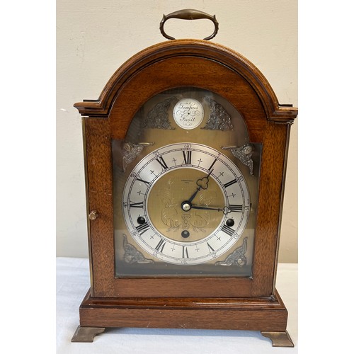 1032 - Mahogany cased Elliot of London mantle clock, retailed by Carmichaels Hull with metal feet and carry... 