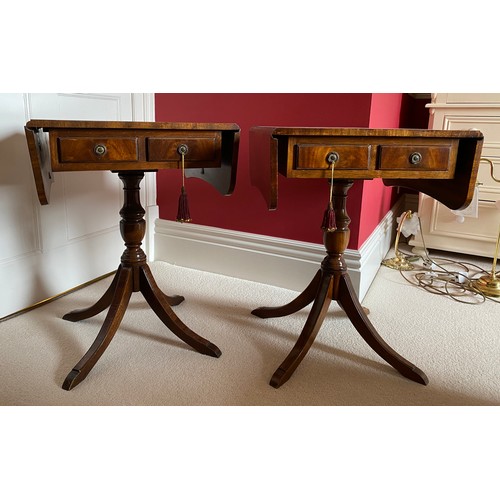 98 - A pair of mahogany 2 drawer drop leaf occasional tables on pedestal bases. 64 h x 46 d x 48cm.