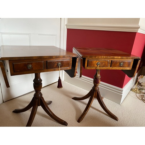 98 - A pair of mahogany 2 drawer drop leaf occasional tables on pedestal bases. 64 h x 46 d x 48cm.