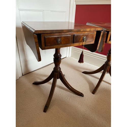 98 - A pair of mahogany 2 drawer drop leaf occasional tables on pedestal bases. 64 h x 46 d x 48cm.