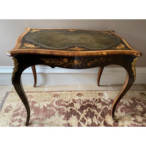 104 - Marquetry inlaid leather topped table with cabriole leg and metal mounts.