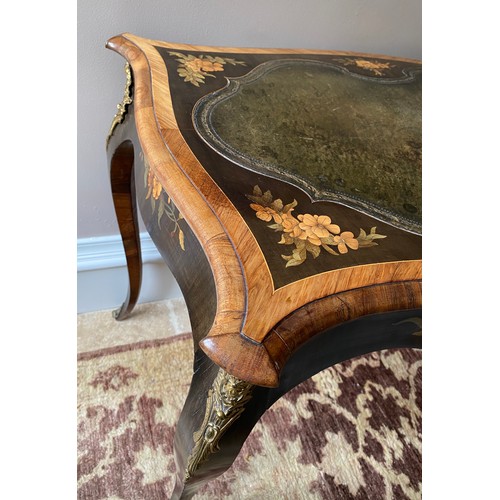 104 - Marquetry inlaid leather topped table with cabriole leg and metal mounts.