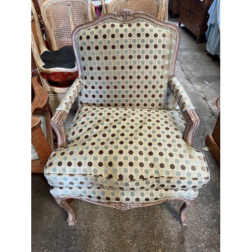 107 - Wooden framed armchair in the French style, upholstered in good quality spotty fabric. 98 h to back ... 