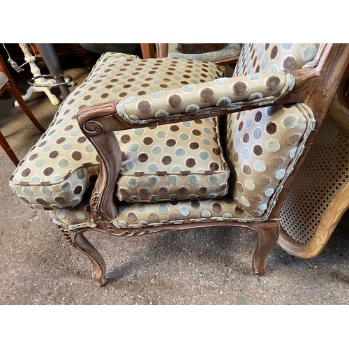 107 - Wooden framed armchair in the French style, upholstered in good quality spotty fabric. 98 h to back ... 