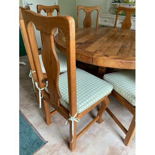 112 - Circular pine dining table and 8 chairs with upholstered cushion sets. Table 140 d x 78cm h. Chairs ... 