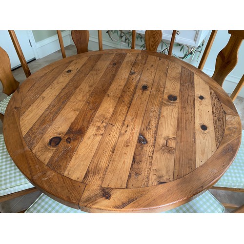 112 - Circular pine dining table and 8 chairs with upholstered cushion sets. Table 140 d x 78cm h. Chairs ... 