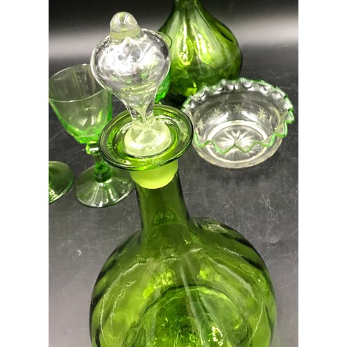 499 - Seven pieces of green glass to include a pair of decanters 17cm h, 3 small glasses 13cm h x 6.5cm d,... 