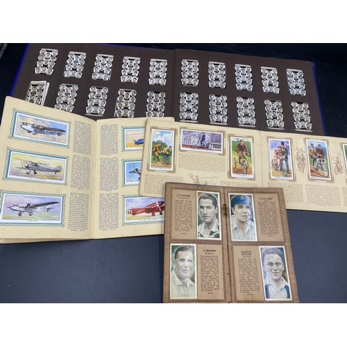 1060 - A large quantity of cigarette cards to include Wills, Player's, famous footballers Carreras, Ogden's... 