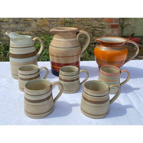 228 - Gray's hand painted pottery to include 3 jugs and 5 beakers, tallest jug 22cm h.