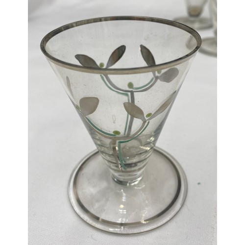 516 - A cocktail set of six glasses 8.5cm h and a cocktail mixer 23cm h, decorated with silver lustre of a... 