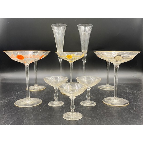 520 - Two champagne flutes 28cm h, five champagne coupes 16cm h, three liqueur glasses etched with classic... 