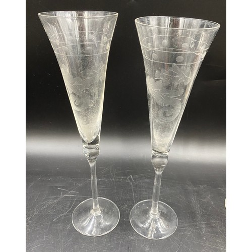 520 - Two champagne flutes 28cm h, five champagne coupes 16cm h, three liqueur glasses etched with classic... 