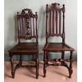 Two late 19thC carved oak side chairs. Ht 115cm.