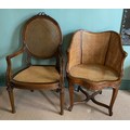 Two French style carved walnut bergère chairs.