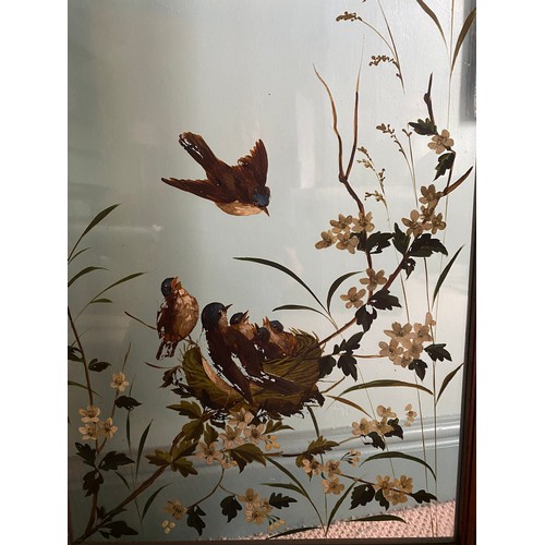 63 - An Edwardian walnut screen with glass panels painted with birds amongst foliage. Approx. 108 h x 154... 