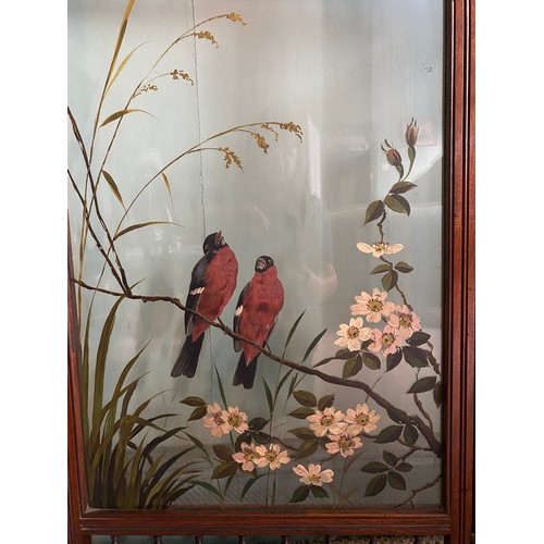 63 - An Edwardian walnut screen with glass panels painted with birds amongst foliage. Approx. 108 h x 154... 