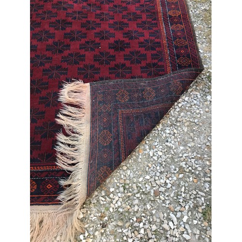 1132 - A red ground Oriental rug, 215cm l x 134cm w.