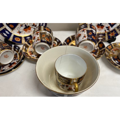 213 - A part 19thC Imari pattern tea service with crown mark to base, 9 saucers, 2 plates, 5 cups, 1 bowl.